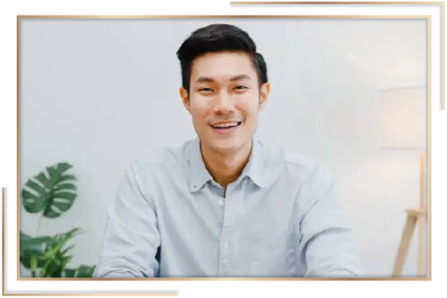 A man in a blue shirt smiling for the camera.