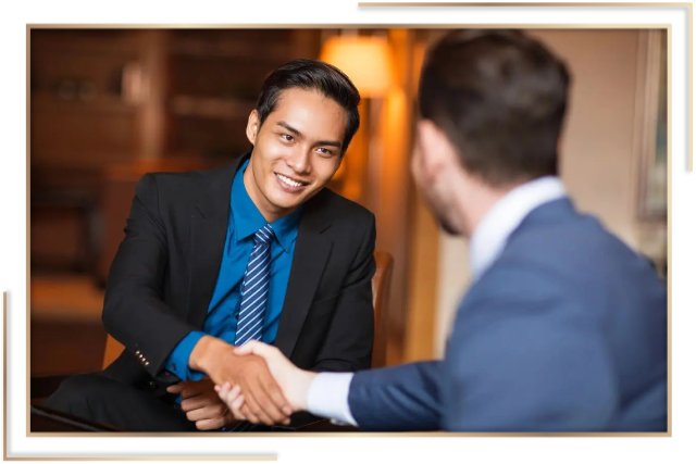 Two men shaking hands in a room.